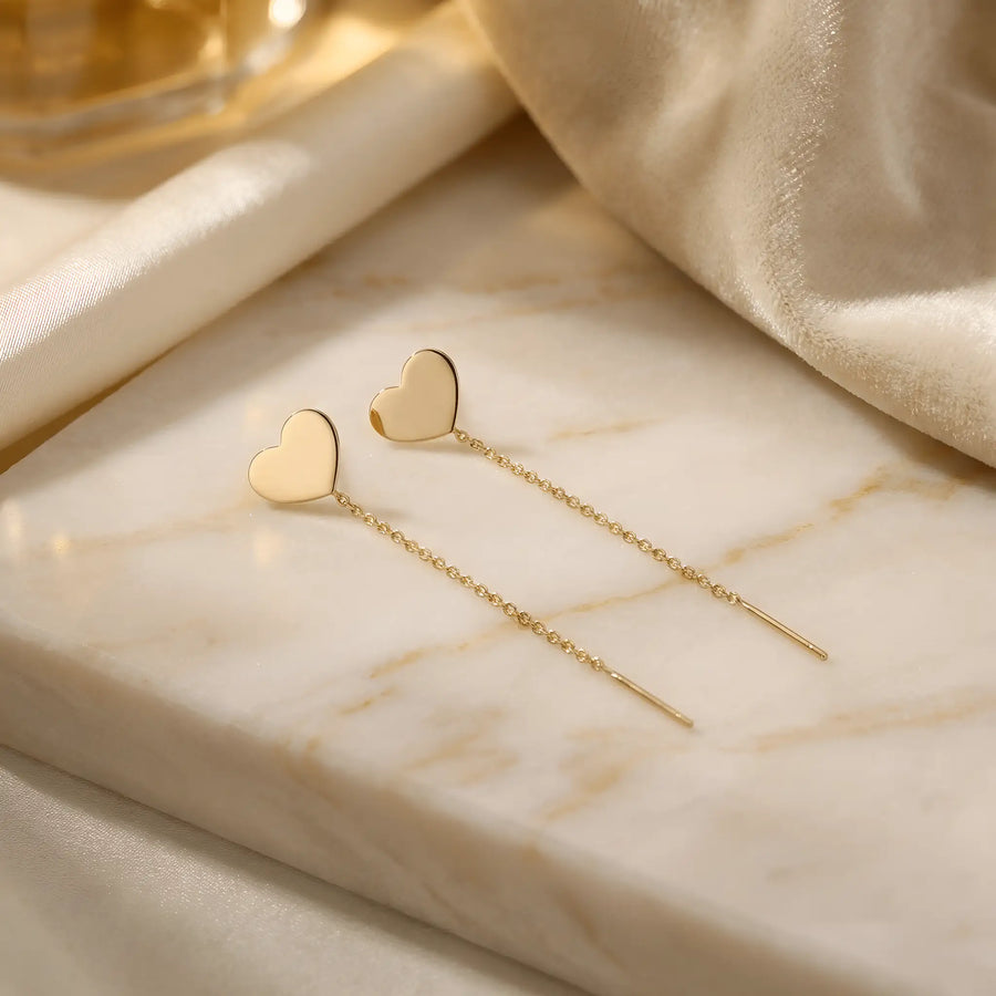 Cercei aur 14K threader inimă mare plină — pereche pe marmură crem cu mătase aurie, inimă plină stilizată și lănțișor delicat 7cm