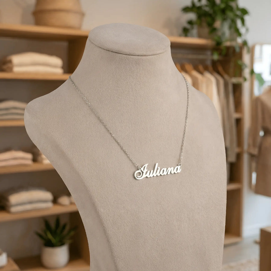 Lănțișor argint 925 rodiat personalizat cu numele Iuliana decupat în scriere cursivă elegantă pe bust display bej în showroom, lanț subțire alb-platinat