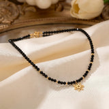Colier choker aur 14k cu cristale negre fațetate, bile de aur și pandantiv floare, lucrat manual