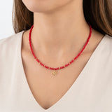 Colier choker cu cristale roșii și pandantiv floare din aur 14k, purtat la gât