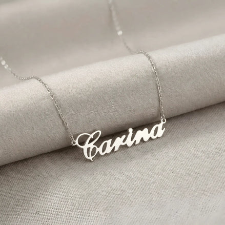 Lănțișor argint 925 rodiat cu numele Carina, pandantiv decupat 38.5x10 mm font cursiv inițiala C deschisă, lanț anchor 46 cm pe textil natural ivory tip in